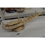 An Indian carving of a elaborate boat, on inscribed base, late 19th century, 32.5 cm long [D] TO BID