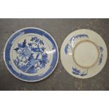 A pair of Chinese blue and white dishes, circa 1900, each painted with a bird perched by a peony, 30