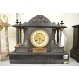 A late 19th century French mantel clock, in elaborate slate case applied with presentation plaque
