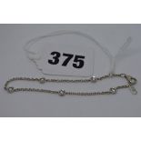 An 18 ct white gold child's chain bracelet, collet-set with five diamonds at intervals, diamonds