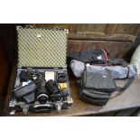 An aluminium camera case containing a Pentax Asahi camera, light meters, a Hoya multi lens, a Tamron