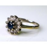 A sapphire, diamond and 18ct white gold flowerhead ring, the central sapphire of approximately 3.