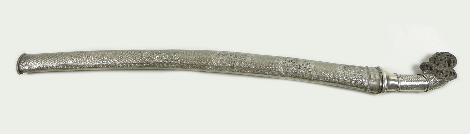 A 19th century white metal and horn handled sword, likely an Indonesian parang or pedang, with