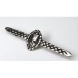A silver bar brooch, decorated in Scandinavian style with a Viking longboat and plaited belt bars,