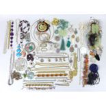 A quantity of costume jewellery, including a mother of pearl carved pendant, a number of jade carved