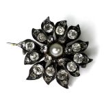 A late Georgian pearl and paste set floral brooch, the central pearl surrounded by individually