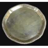 A George III small silver tray, of octagonal form with reeded rim, three scroll feet, maker's