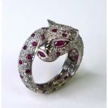 A 18ct white gold, diamond and ruby ring in the form of a coiled panther, by Brooks & Bentley,