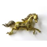 An 18ct gold horse brooch, modelled in a galloping pose, with textured yellow gold body, diamond set