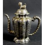 A 19th century Chinese silver wine pot, of lobed tapering form, the cover with shi shi finial,