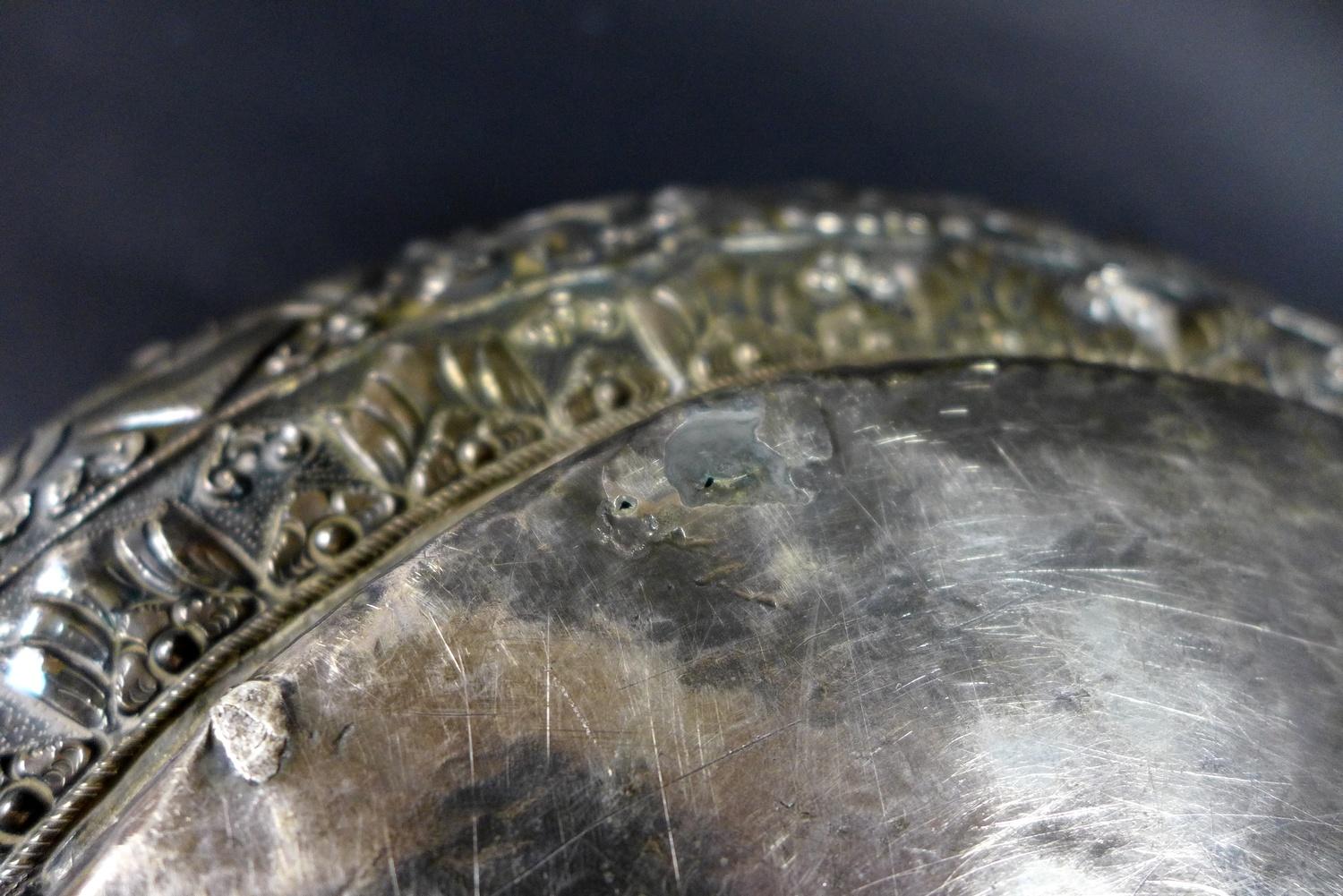 A late 19th century Thai silver large bowl, repousse decorated in relief with three face masks and - Image 9 of 10