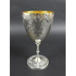 A Victorian silver goblet, with gilt interior, engraved decoration raised upon a circular base, 9.