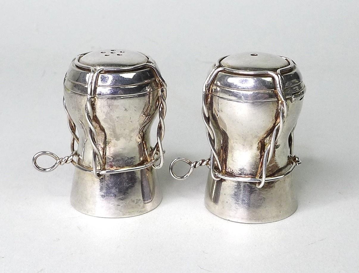 A pair of contemporary silver novelty salt and pepper pots, modelled as champagne corks, AD,