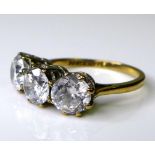 A 9ct gold and paste three stone ring, each brilliant cut paste approximately 6mm diameter, on a 9ct