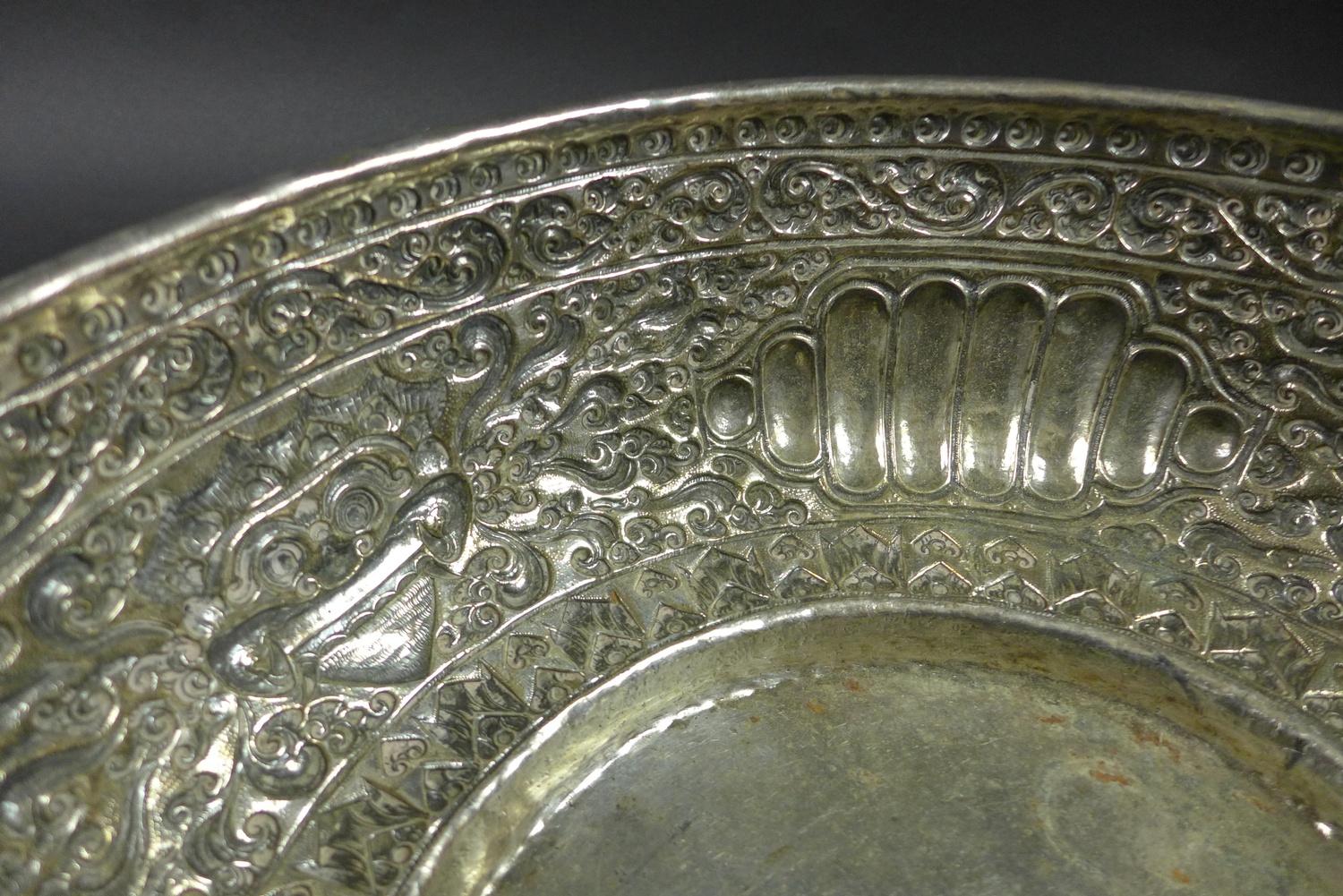 A late 19th century Thai silver large bowl, repousse decorated in relief with three face masks and - Image 7 of 10