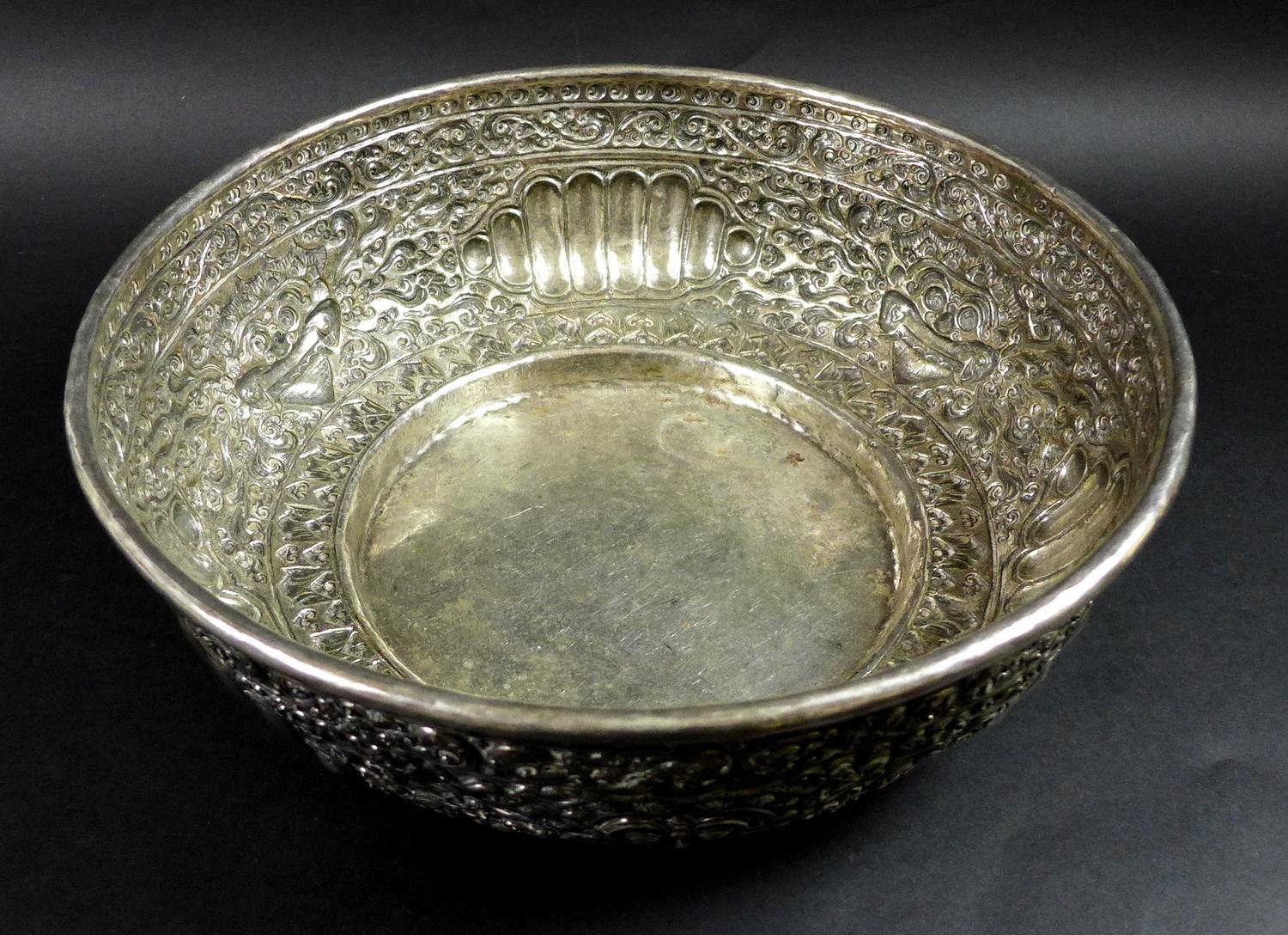 A late 19th century Thai silver large bowl, repousse decorated in relief with three face masks and - Image 2 of 10