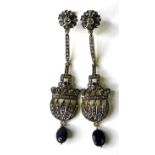 A pair of chandelier style drop earring set with diamonds, flower set to the top with peridot