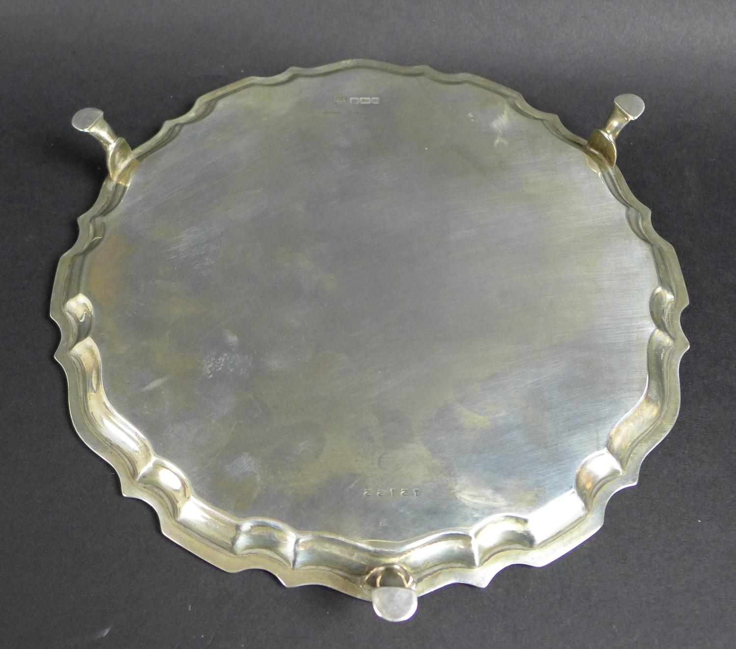 A George V silver tray, of circular form with Chippendale pie crust edge, raised on three feet, - Image 5 of 7