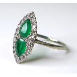 An Art Deco emerald, diamond and platinum dress ring, of scalloped marquise form, with two pear
