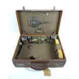 An early 20th century travelling dressing case with silver backed and mounted accoutrements,