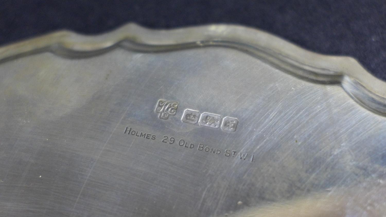 A George V silver tray, of circular form with Chippendale pie crust edge, raised on three feet, - Image 6 of 7