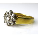 An 18ct gold and diamond flowerhead ring, formed as a chrysanthemum with a double row of diamonds