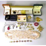 A group of designer costume jewellery, including a a brooch formed as a pair of bejewelled lips with