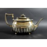 A George III silver teapot, of squat rectangular form with broad fluted lower body and gadrooned