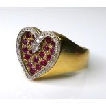 A 9ct gold, diamond and ruby valentine heart ring, formed of eighteen rubies within a recessed heart