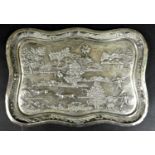 A South East Asian white metal repousse tray, late 19th / early 20th century, decorated in relief