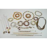 A quantity of amber style costume jewellery, including a set of silver and amber style