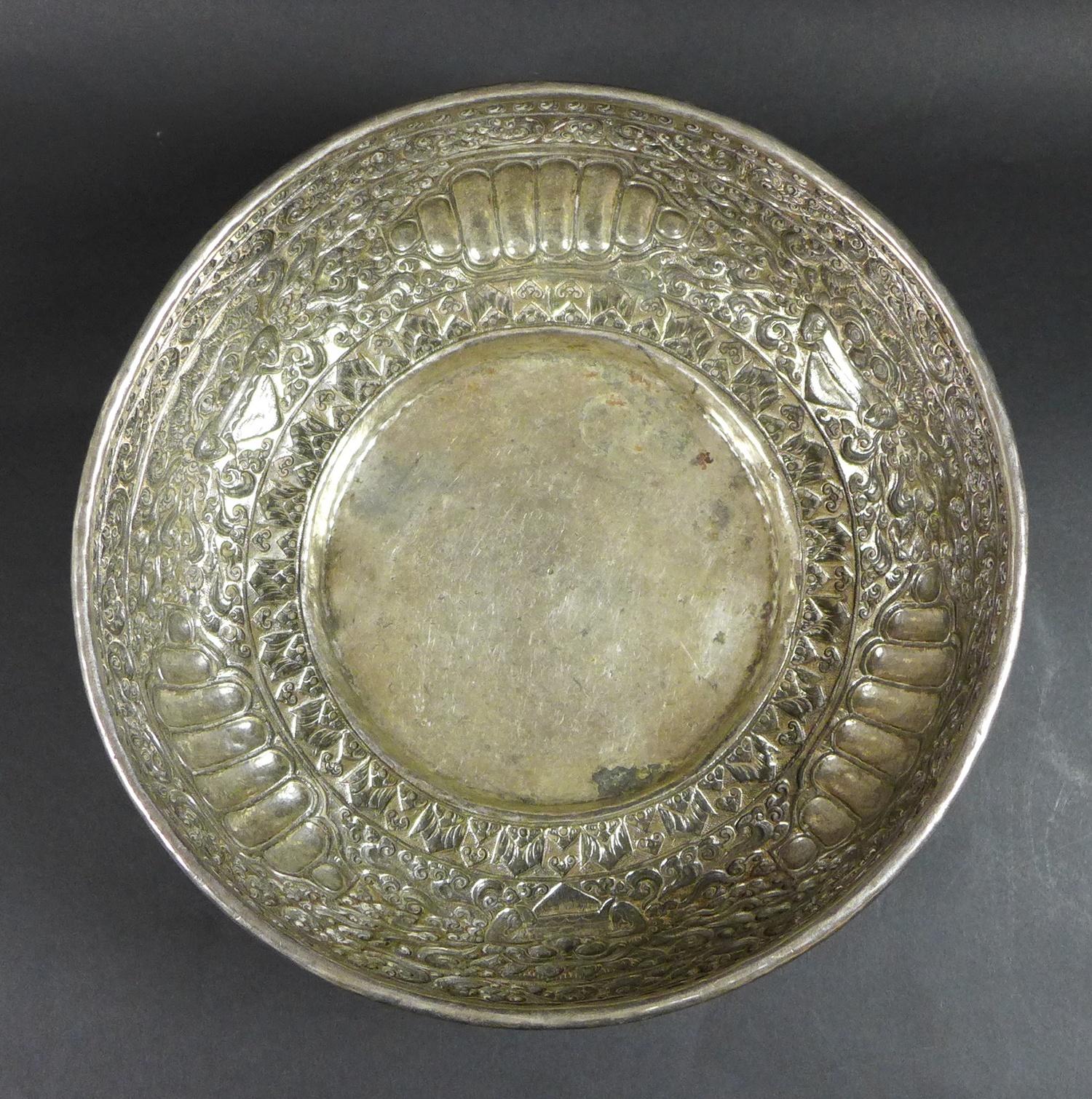 A late 19th century Thai silver large bowl, repousse decorated in relief with three face masks and - Image 6 of 10