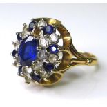 A sapphire, paste and 9ct gold dress ring, the central oval cut sapphire of approximately 5mm by