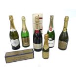 A group of four and a half bottles of champagne and sparking wine, including a bottle of Moet &