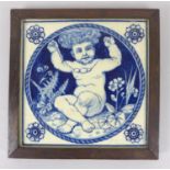A 19th century Mintons blue and white tile, featuring a cherub holding up a necklace, bearing