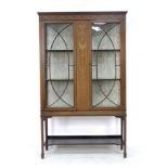 An Edwardian mahogany display cabinet, with marquetry inlaid central panel flanked by twin