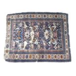 A Persian Tekke rug, decorated in dark blue, white, orange and red, 170 by 130cm.