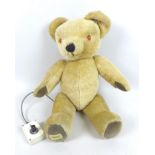 A vintage Merrythought talking bear, with lead attached controller, plush fur, plastic light up