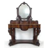A Victorian mahogany dressing table, with oval mirror on shaped supports, three trinket drawers, the
