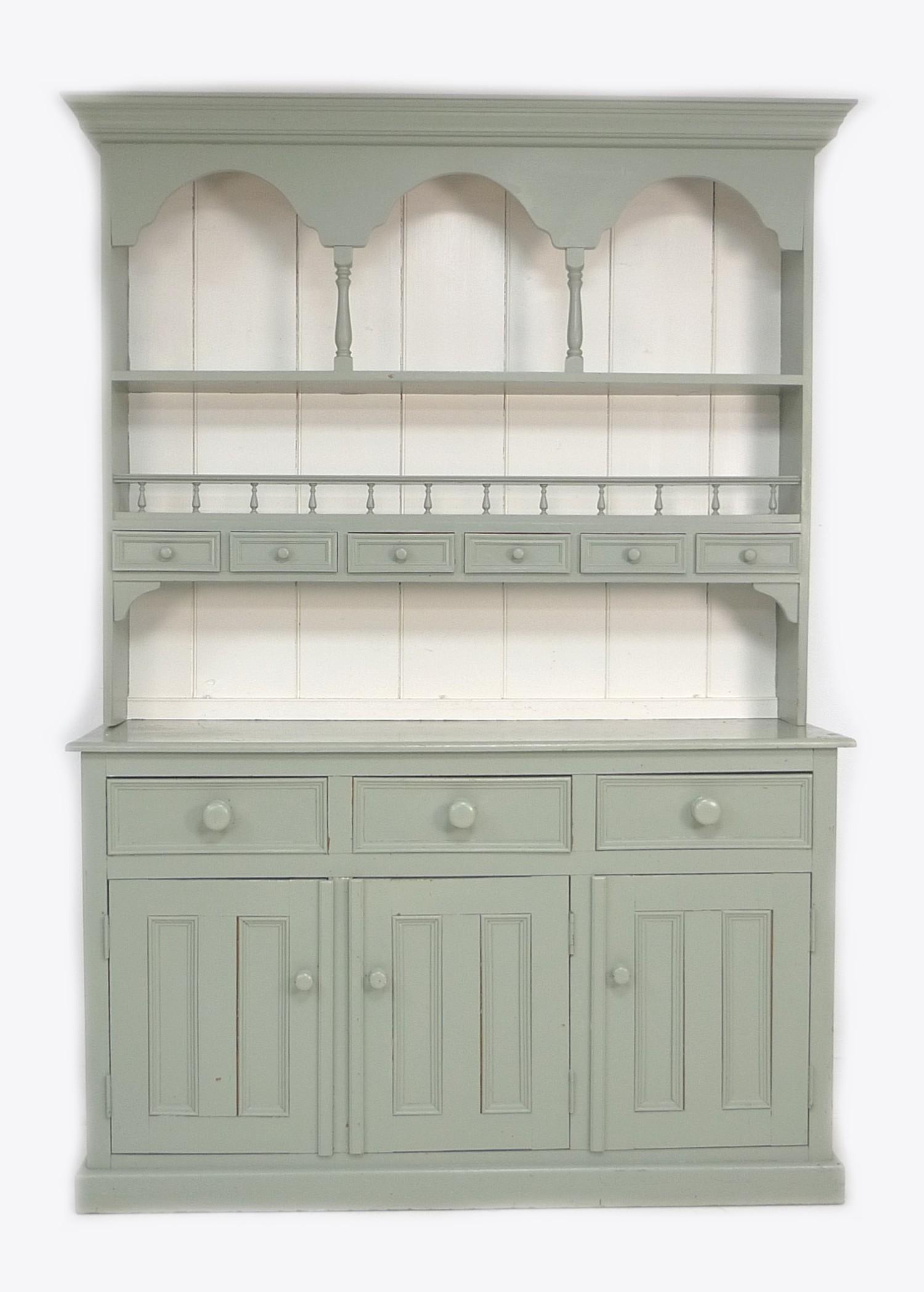A modern painted pine dresser, sage green and white, the plate rack fitted with six spice drawers