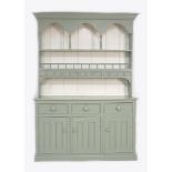 A modern painted pine dresser, sage green and white, the plate rack fitted with six spice drawers