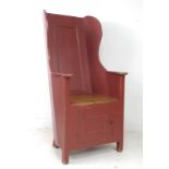 A modern pine lambing chair, in 18th century style, red painted with distressed finish, cupboard