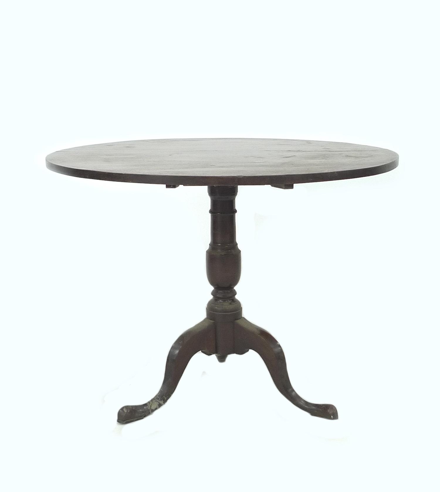 A Georgian mahogany tea table, circular tilt up, raised on a turned column and three cabriole