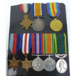 A WWI trio and a WWII group of medals, comprising A 1914-15 star, a War medal and Defence medals,