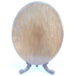 A late Victorian mahogany breakfast table, the oval tilt top with moulded edge, on a baluster column