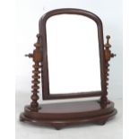 A Victorian mahogany dressing table mirror, with turned support and bow fronted base, 58 by 22 by