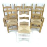 A set of eight modern pine dining chairs, with ladder backs and drop in rush seats, one later