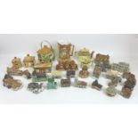 A large collection of ceramic buildings, prominently from the 'Britain in Miniature' series from the