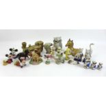 A group of mixed ceramic figurines, including a set of three hand painted Toby Jug miniatures, a