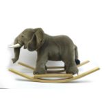 A Steiff Elephant rocking toy, with wooden handles and base, without certificate, 39.5 by 108 by